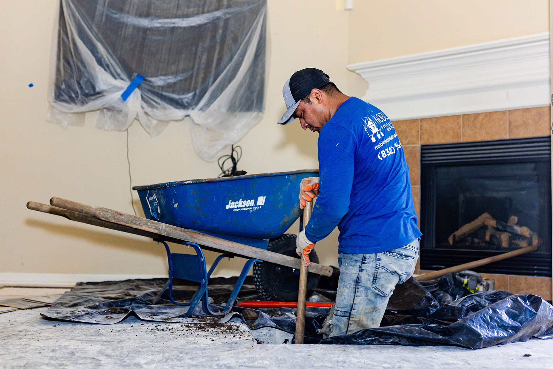 Noble-Foundation-Repair---Man-fixing-a-foundation-to-a-home A Noble Foundation Repair worker doing work at a home in Cypress Texas.